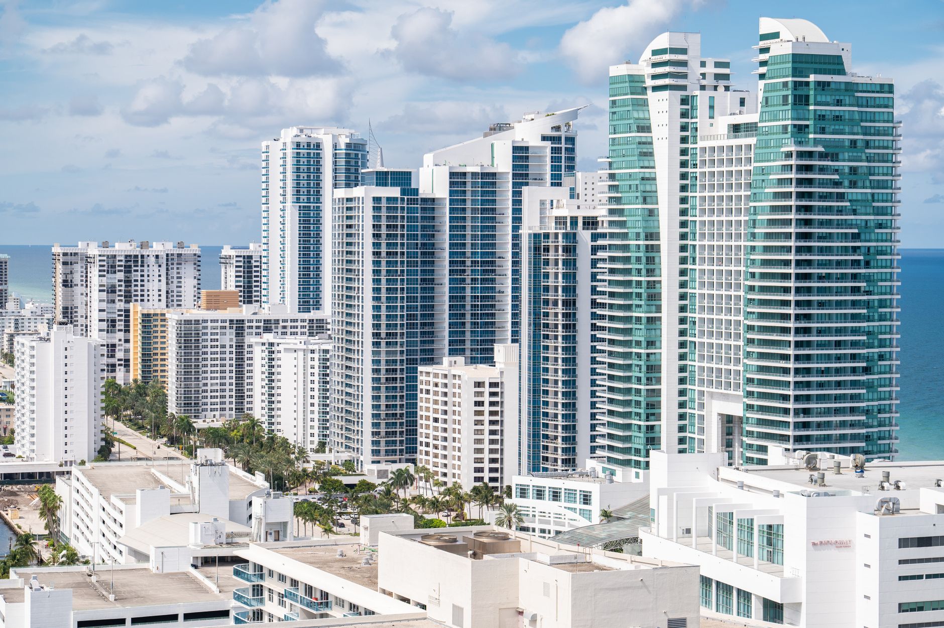 Aerial view of Hollywood, Florida's modern skyline along the coast with high-rise buildings and ocean views.